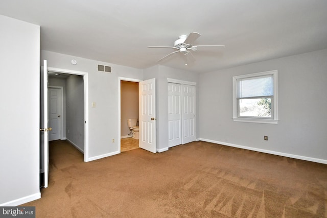 unfurnished bedroom featuring a ceiling fan, baseboards, visible vents, carpet floors, and a closet