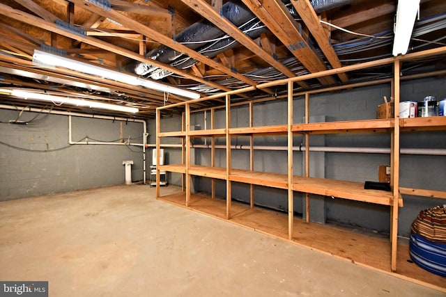 unfinished basement featuring water heater