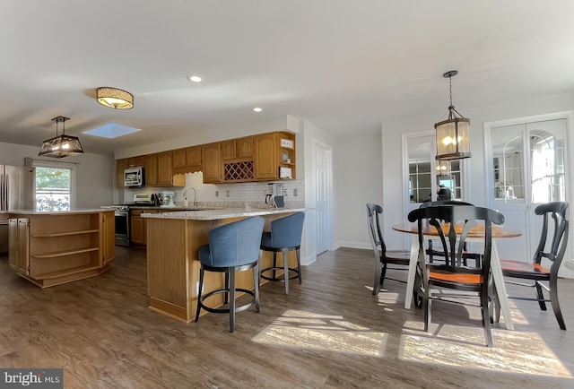 kitchen featuring open shelves, stainless steel appliances, backsplash, and a sink