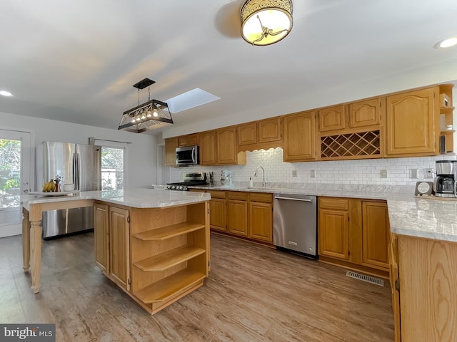 kitchen featuring a sink, open shelves, a healthy amount of sunlight, and stainless steel appliances