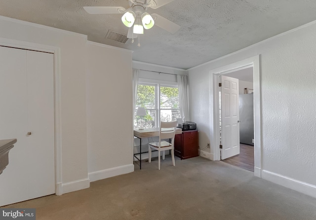 carpeted office space featuring visible vents, baseboards, a textured ceiling, and crown molding