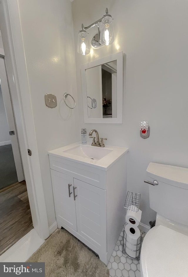 half bath featuring toilet and vanity