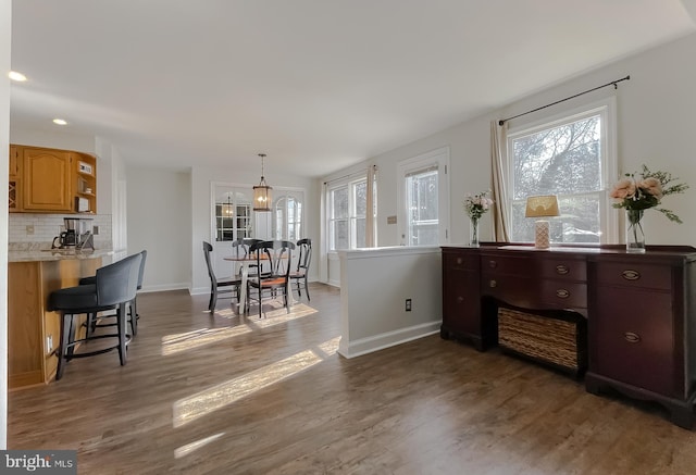 interior space featuring recessed lighting, baseboards, and dark wood-type flooring