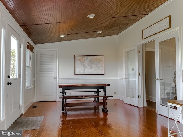 foyer entrance featuring visible vents, vaulted ceiling, wooden ceiling, french doors, and wood finished floors