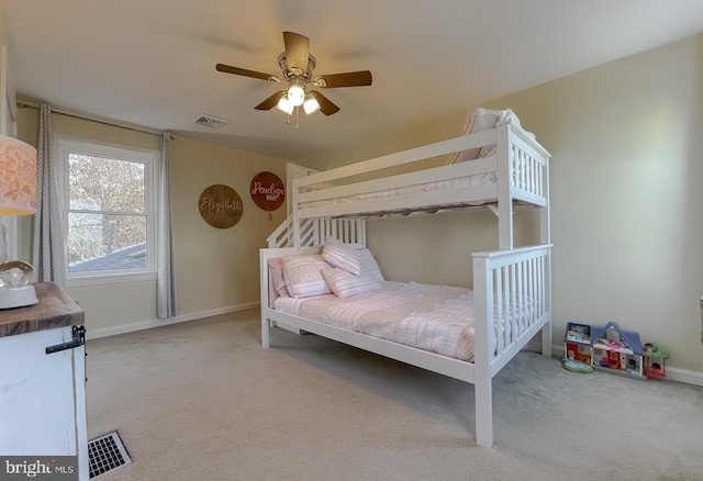 carpeted bedroom with a ceiling fan, baseboards, and visible vents