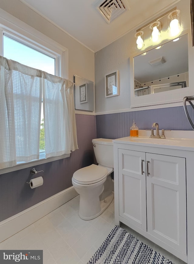 full bathroom with vanity, toilet, and visible vents