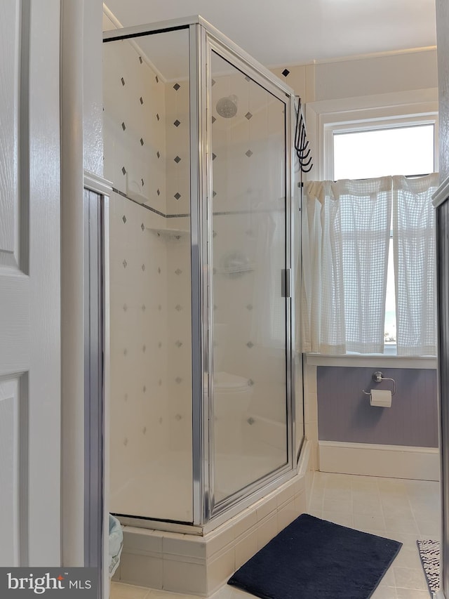 full bath with tile patterned floors and a stall shower