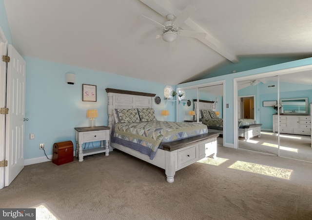 bedroom featuring lofted ceiling with beams, carpet floors, two closets, and ceiling fan