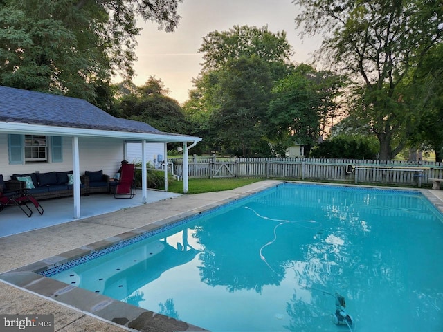 view of pool featuring outdoor lounge area, a patio area, a fenced in pool, and a fenced backyard