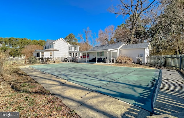 rear view of property with a patio and fence