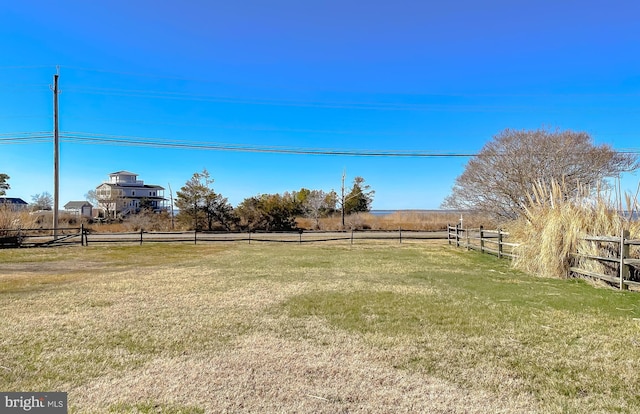 view of yard featuring a rural view and fence