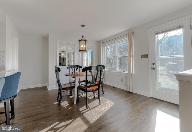 dining room with wood finished floors and baseboards