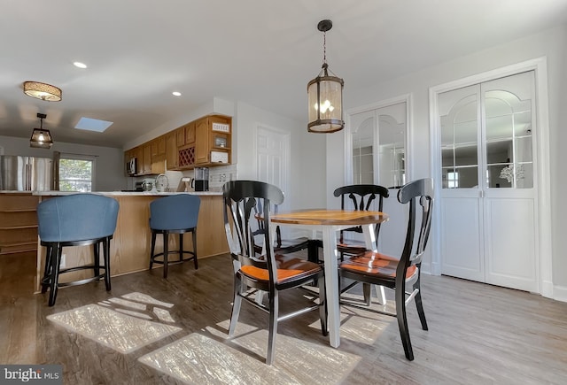 dining area with recessed lighting and light wood finished floors