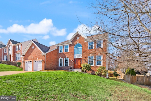 view of front facade with a front lawn, fence, concrete driveway, an attached garage, and brick siding