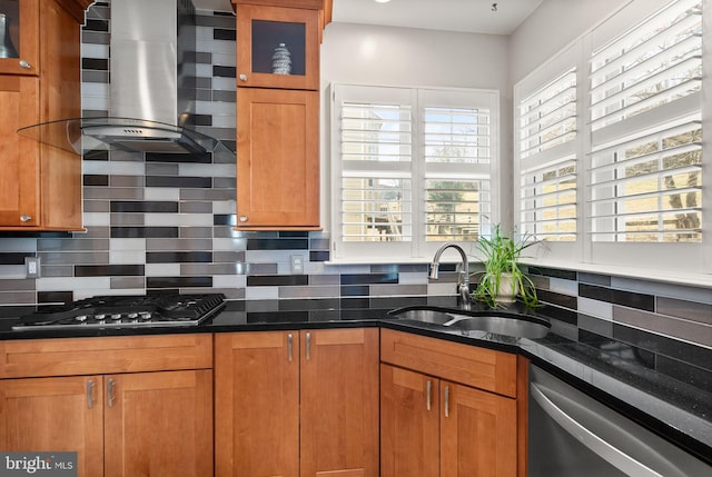 kitchen with a sink, gas cooktop, stainless steel dishwasher, ventilation hood, and brown cabinetry