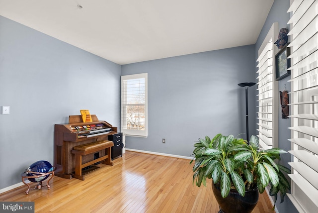 living area featuring hardwood / wood-style flooring and baseboards