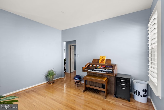 sitting room featuring baseboards and light wood-style floors