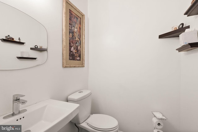 bathroom featuring toilet and a sink