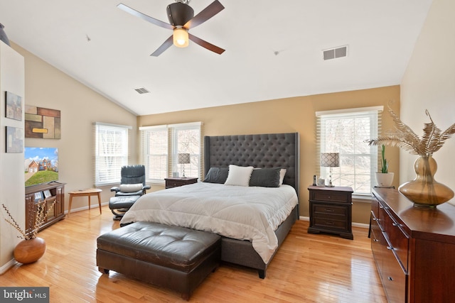 bedroom with visible vents, baseboards, light wood-style floors, and vaulted ceiling