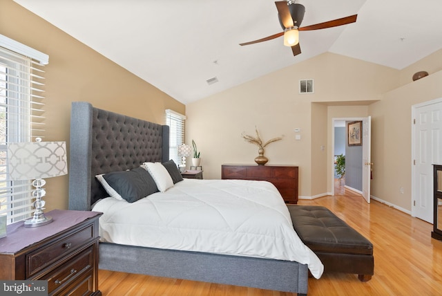 bedroom with vaulted ceiling, light wood-style flooring, and visible vents