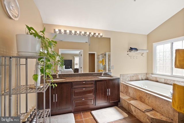 bathroom featuring tile patterned floors, a garden tub, a stall shower, ensuite bathroom, and vaulted ceiling