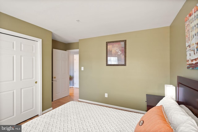 bedroom featuring baseboards and light wood-type flooring