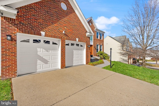 view of home's exterior featuring brick siding, an attached garage, and concrete driveway