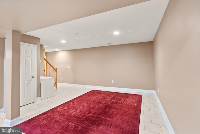 finished basement featuring recessed lighting, baseboards, light tile patterned flooring, and stairs