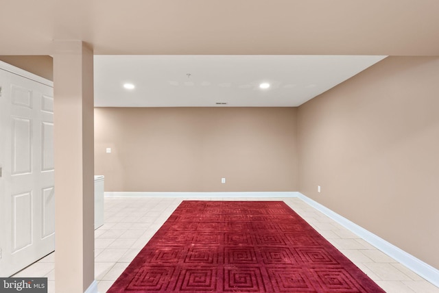 basement with light tile patterned floors, recessed lighting, and baseboards