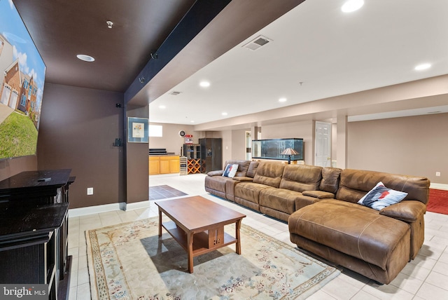 living area with light tile patterned floors, recessed lighting, visible vents, and baseboards