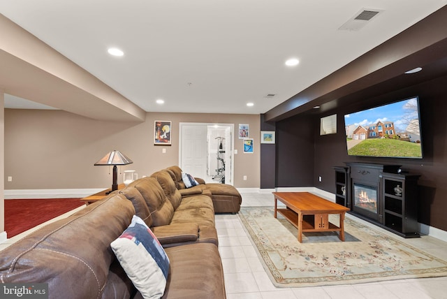 living area with recessed lighting, visible vents, and baseboards