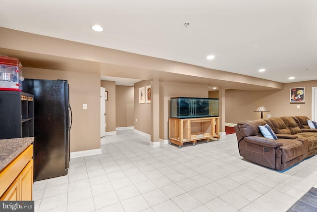 living room featuring light tile patterned flooring, recessed lighting, and baseboards