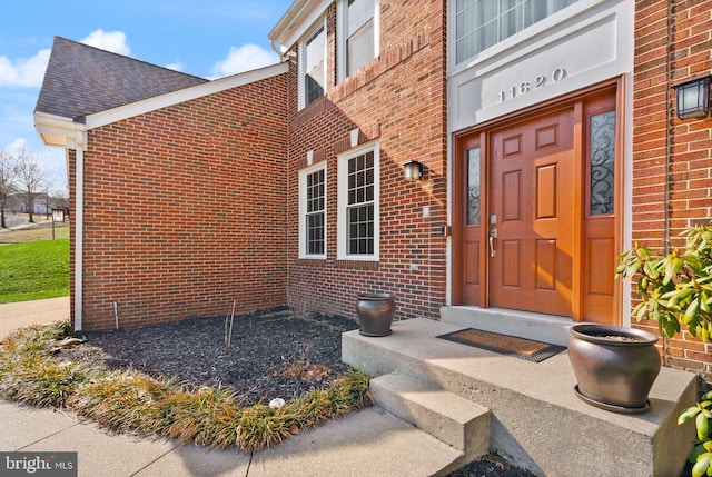 property entrance with brick siding