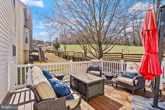 wooden terrace with an outdoor hangout area and stairs