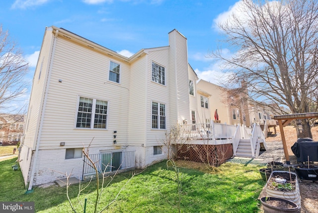 rear view of property featuring central AC unit, a lawn, a chimney, and a deck