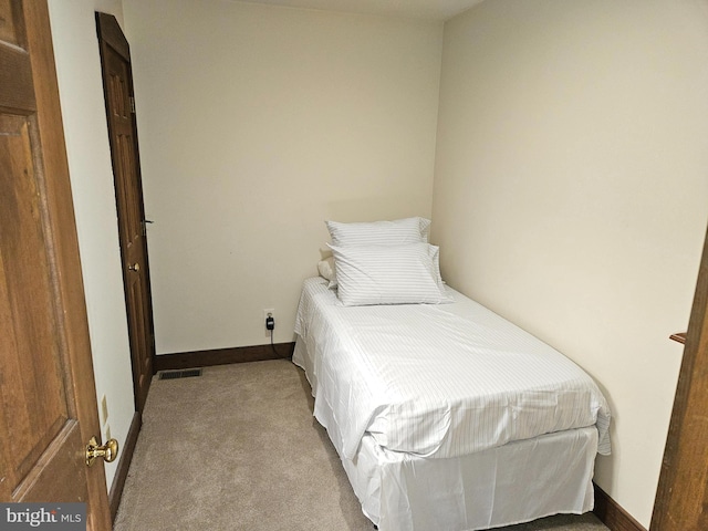 bedroom with visible vents, baseboards, and carpet