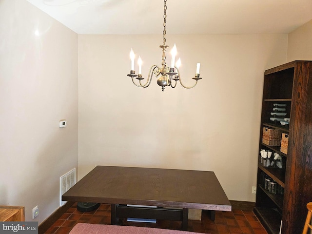 dining area featuring visible vents, baseboards, and a notable chandelier