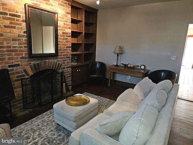 living area featuring dark wood finished floors and a fireplace