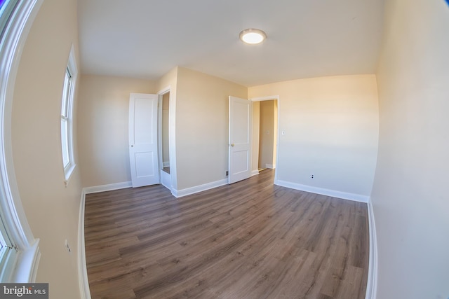 unfurnished bedroom with baseboards and wood finished floors