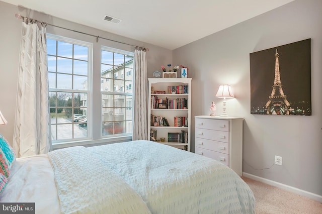 carpeted bedroom featuring visible vents and baseboards