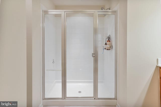 bathroom featuring a stall shower and vanity