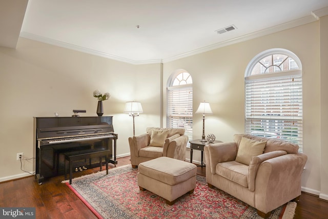 living area featuring a wealth of natural light, visible vents, and dark wood-style flooring