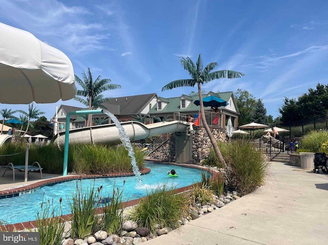 community pool featuring a patio and fence