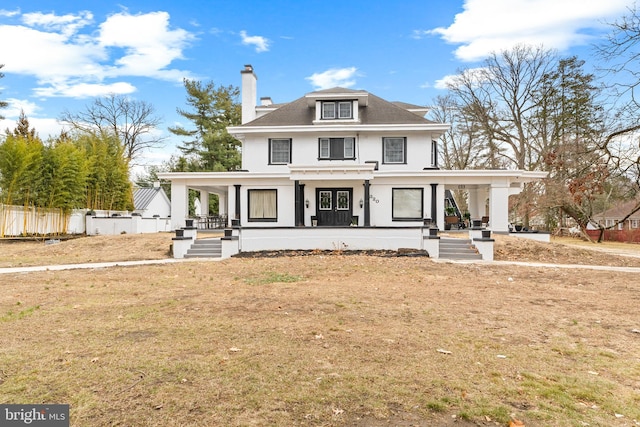 view of front of property with a front yard, a porch, a chimney, and fence