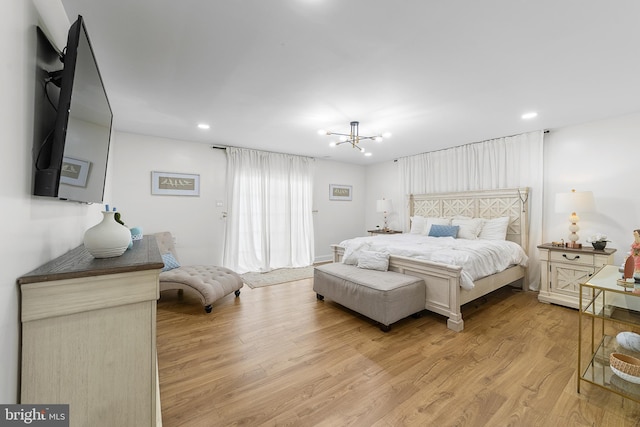 bedroom with recessed lighting, light wood-style flooring, and an inviting chandelier