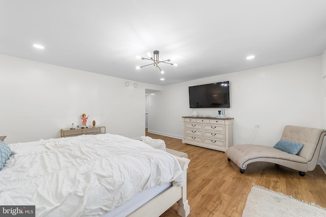 bedroom featuring recessed lighting, wood finished floors, and a chandelier