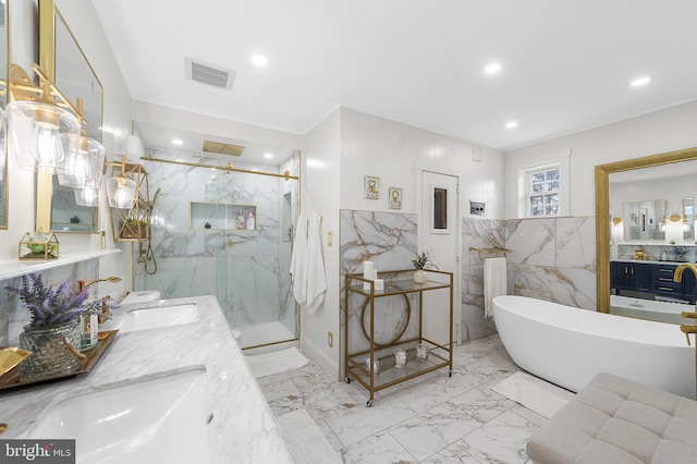 bathroom with a marble finish shower, visible vents, recessed lighting, marble finish floor, and a sink