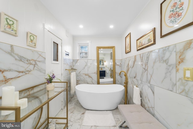 full bath with marble finish floor, recessed lighting, tile walls, a soaking tub, and vanity