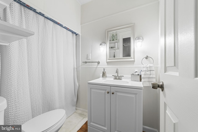 bathroom featuring curtained shower, toilet, and vanity