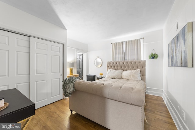 bedroom featuring wood finished floors and baseboards